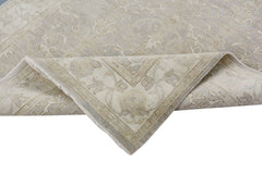 A handmade Afghan Chobi rug featuring a traditional floral pattern in neutral beige tones.