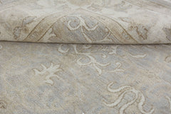 A handmade Afghan Chobi rug featuring a neutral, wood-toned floral pattern in handspun wool.