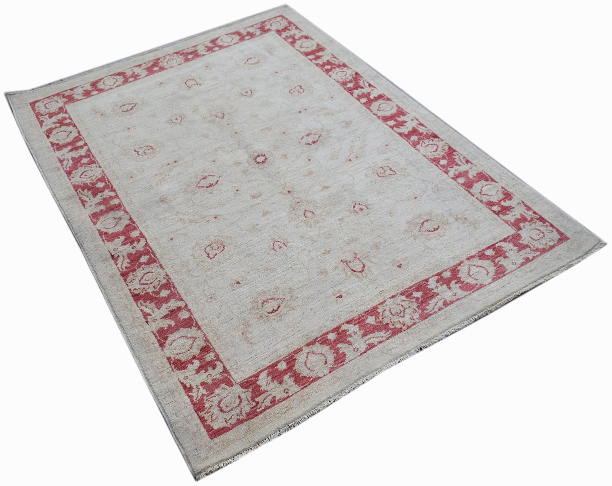 An Afghan Chobi rug featuring a cream field with red floral motifs and a matching red border.