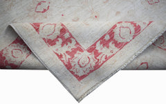 A handwoven Afghan Chobi rug featuring a cream field with a red floral border and fringe.