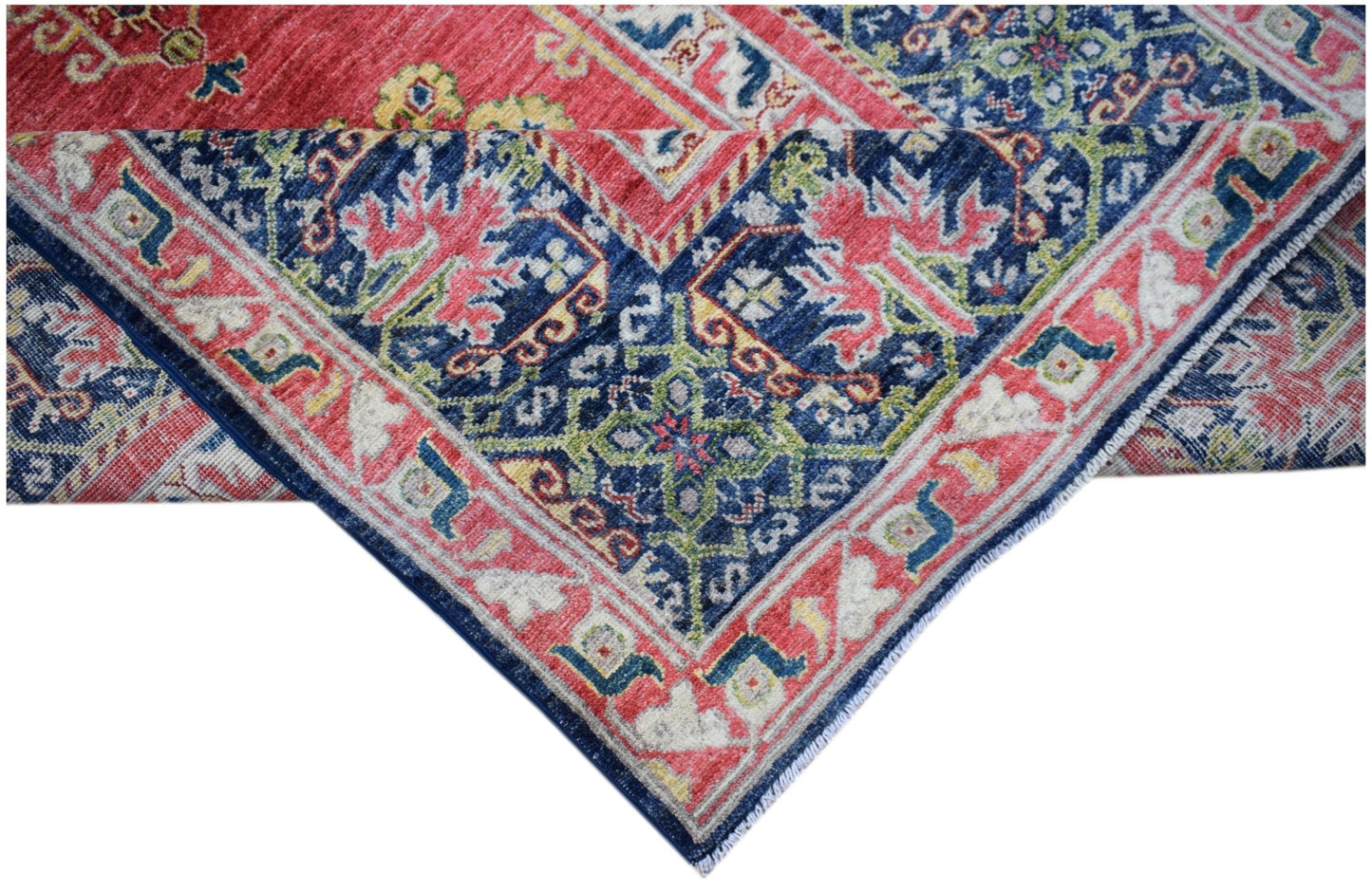 A handwoven Afghan Chobi rug featuring a traditional floral pattern in red, blue, and green tones.