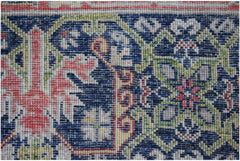 A close-up of a handwoven Afghan Chobi rug featuring intricate floral patterns in blue and red.