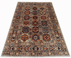 A rectangular Afghan Chobi rug featuring a geometric pattern of octagonal motifs in earthy tones.