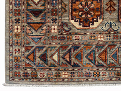 A handmade Afghan Chobi rug featuring intricate geometric patterns in earthy, wood-toned hues.