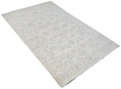 An Afghan Chobi rug featuring a subtle, light-toned floral pattern on a handwoven wool pile.