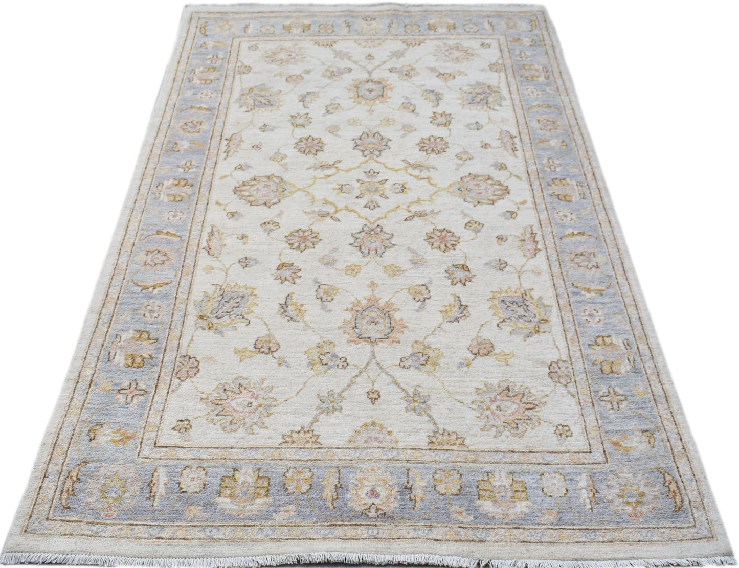 A rectangular Afghan Chobi rug featuring a traditional floral pattern in soft blue and beige tones.