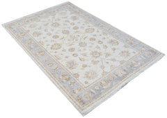 An Afghan Chobi rug featuring a traditional floral pattern in soft beige and blue tones.