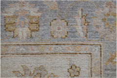 A close-up of a handwoven Afghan Chobi rug featuring traditional floral patterns in muted tones.