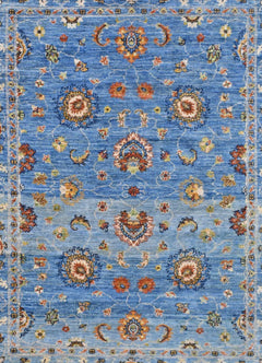 Handwoven Afghan Chobi rug featuring a traditional floral pattern in shades of blue and orange.