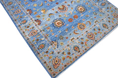 A handmade Afghan Chobi rug featuring intricate floral patterns in shades of blue and orange.
