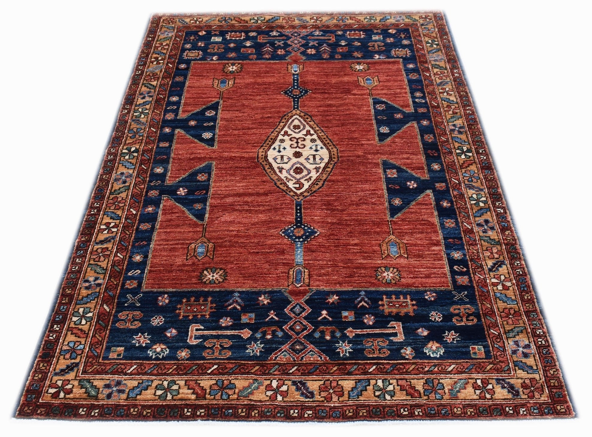 A rectangular Afghan Chobi rug featuring a central diamond medallion on a red field with blue borders.