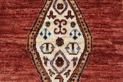 A handmade Afghan Chobi rug featuring a central diamond medallion with intricate geometric motifs.