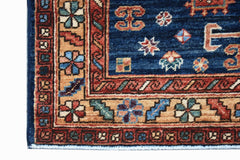 A corner view of a handwoven Afghan Chobi rug featuring intricate floral patterns in earthy tones.