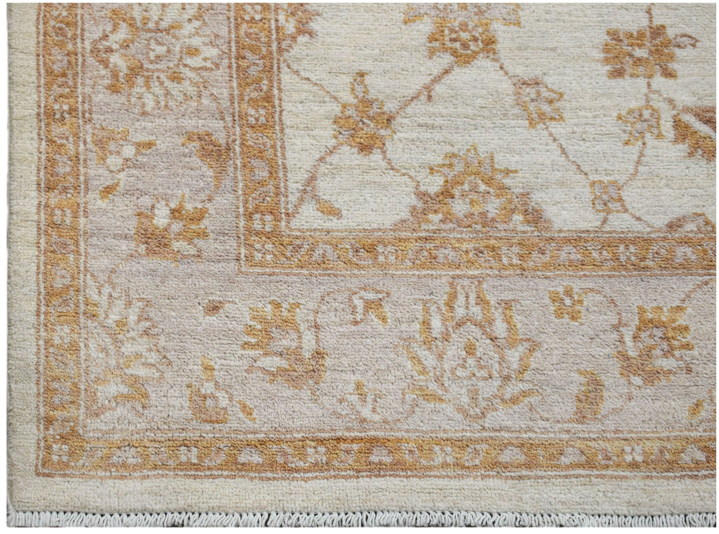 A handmade Afghan Chobi rug featuring a traditional floral pattern in soft beige and brown tones.