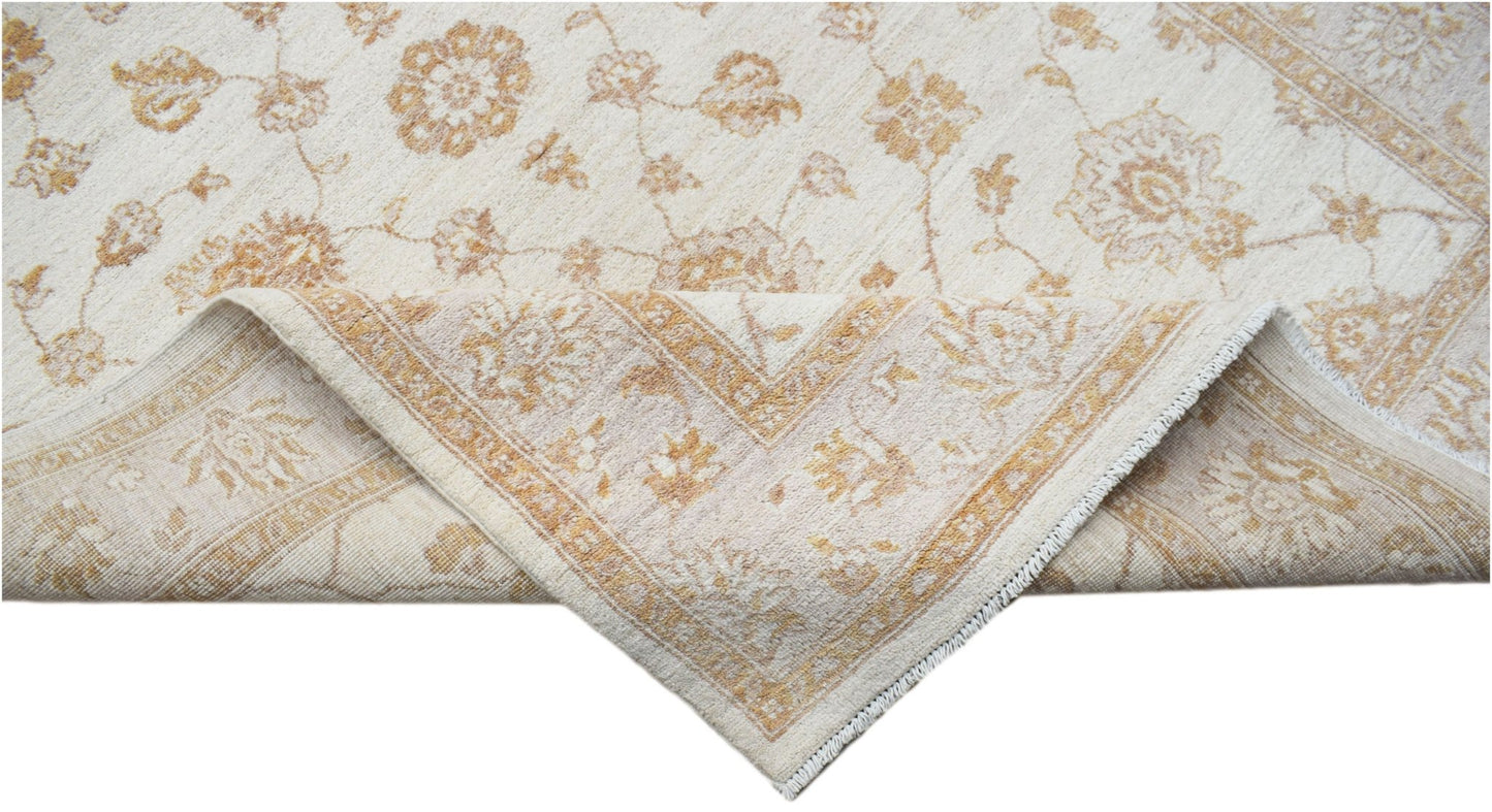 A handwoven Afghan Chobi rug featuring a cream background with soft gold floral patterns.
