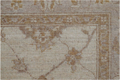 A close-up of a handwoven Afghan Chobi rug featuring traditional floral patterns in earthy tones.
