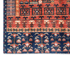 Handwoven Afghan Chobi rug featuring traditional floral patterns in red and blue wool.