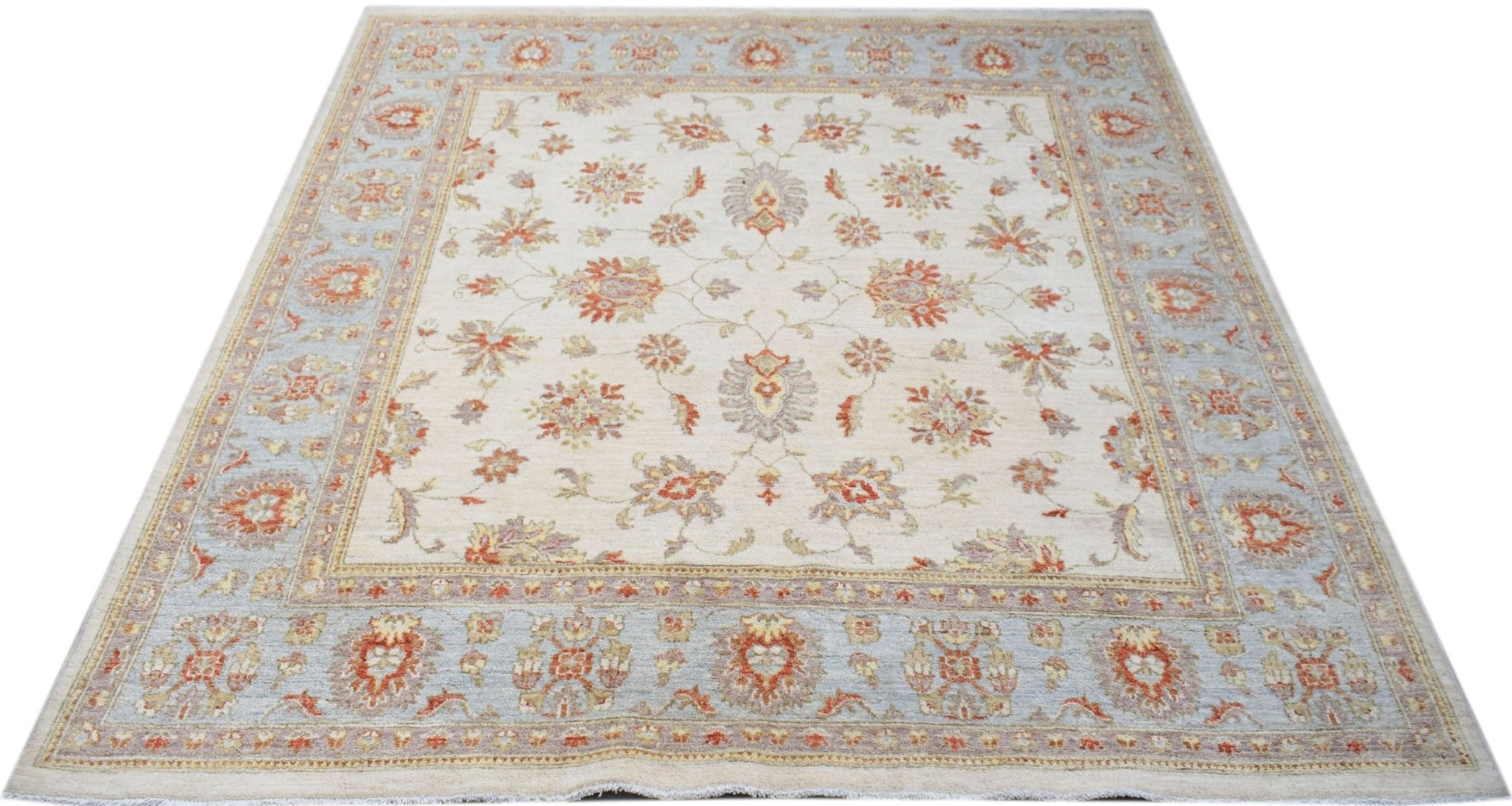 A handmade Afghan Chobi rug featuring a floral pattern in soft orange and blue on a cream field.