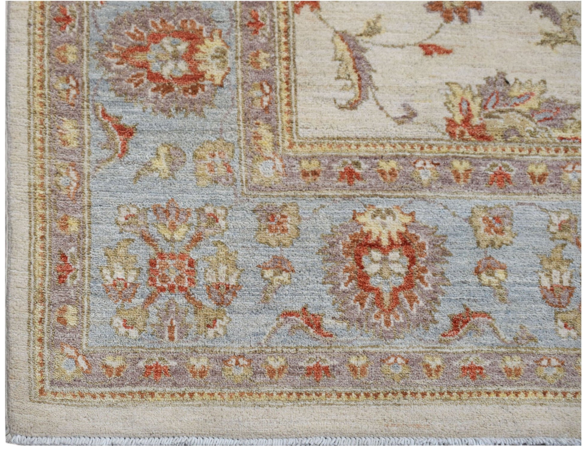 A handwoven Afghan Chobi rug featuring a traditional floral pattern in soft blue and cream tones.