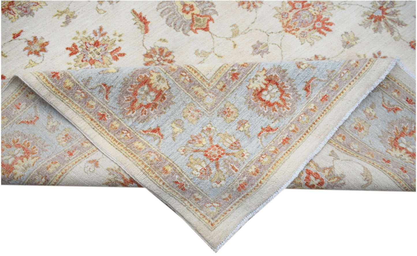 A handwoven Afghan Chobi rug featuring a floral pattern in soft orange and blue tones.