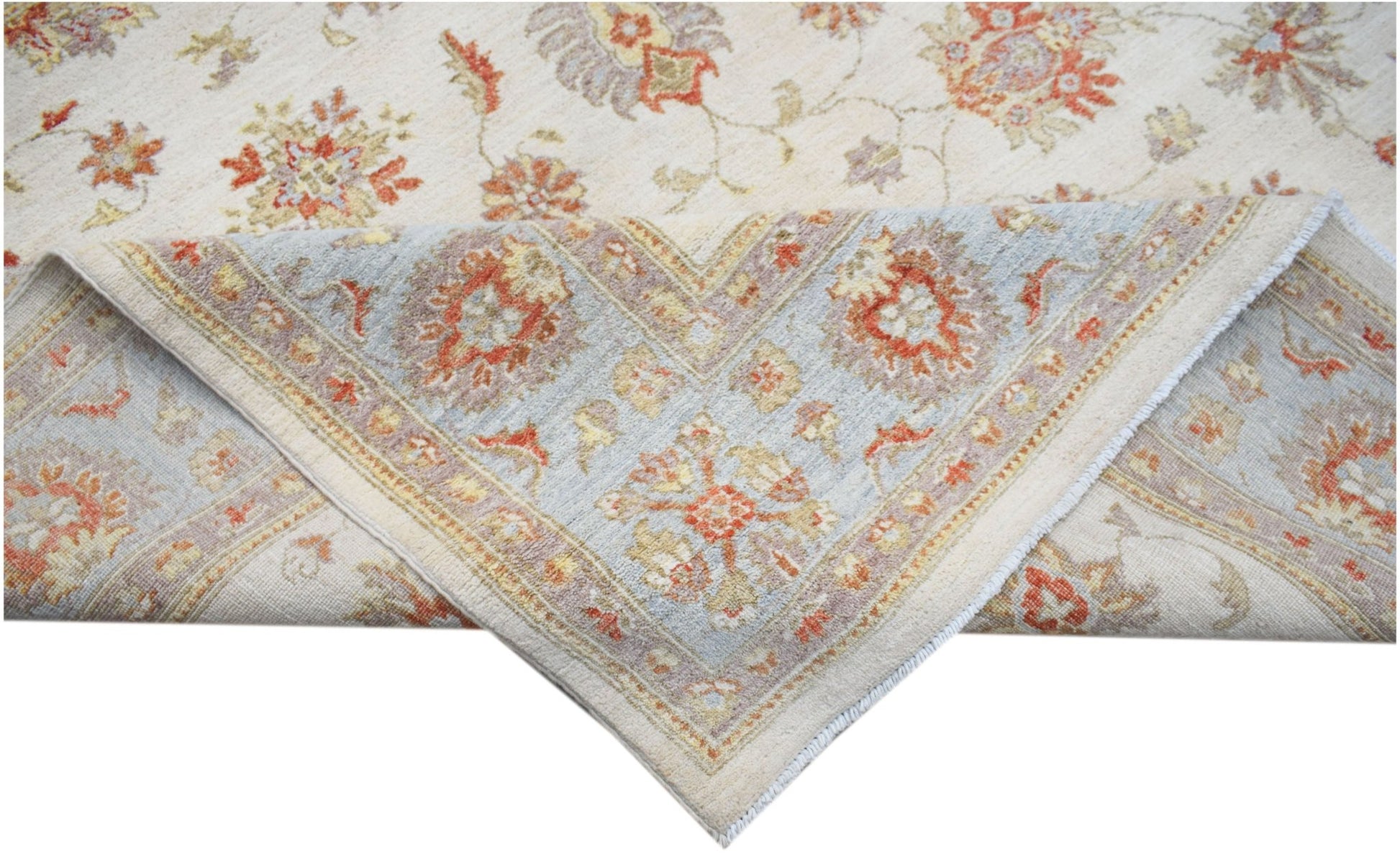 A handwoven Afghan Chobi rug featuring a floral pattern in soft orange and blue tones.