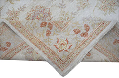 A handwoven Afghan Chobi rug featuring a floral pattern in soft earth tones on a cream background.