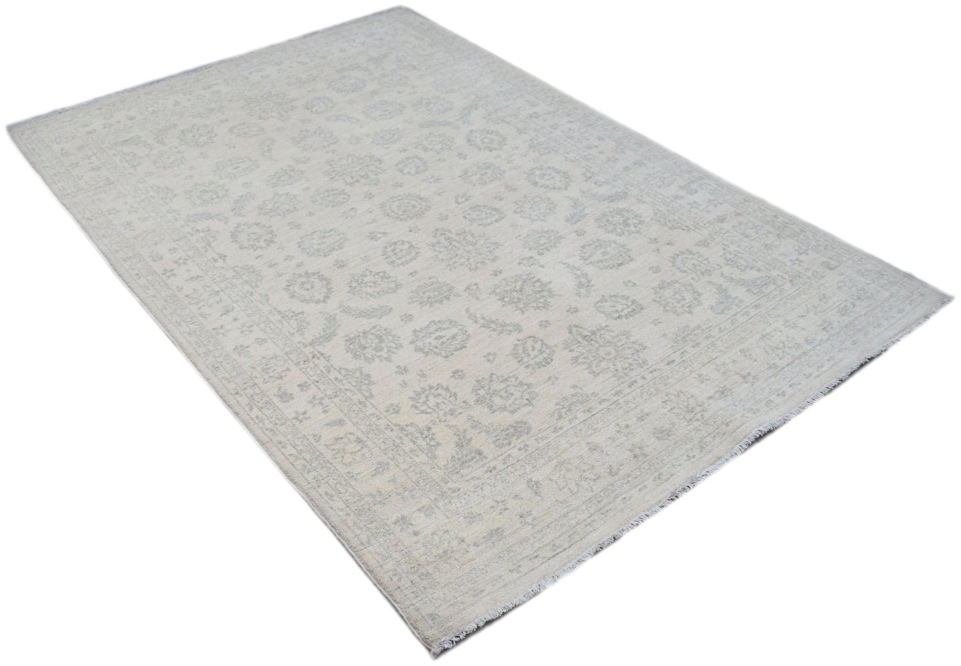 An Afghan Chobi rug featuring a traditional floral pattern in soft grey and cream tones.