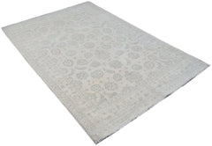 An Afghan Chobi rug featuring a traditional floral pattern in soft grey and cream tones.