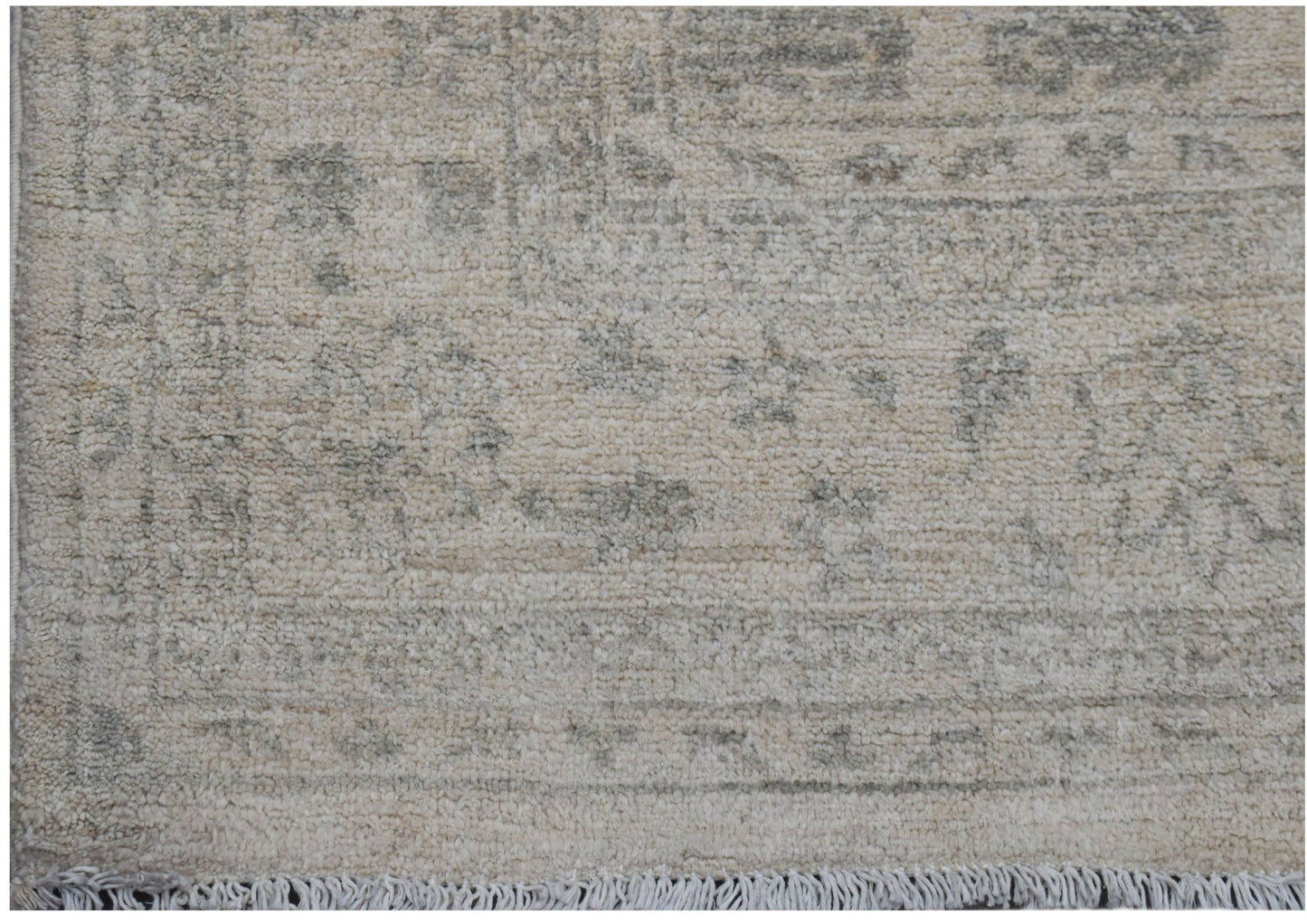 A handwoven Afghan Chobi rug featuring a traditional pattern in soft beige and grey tones.