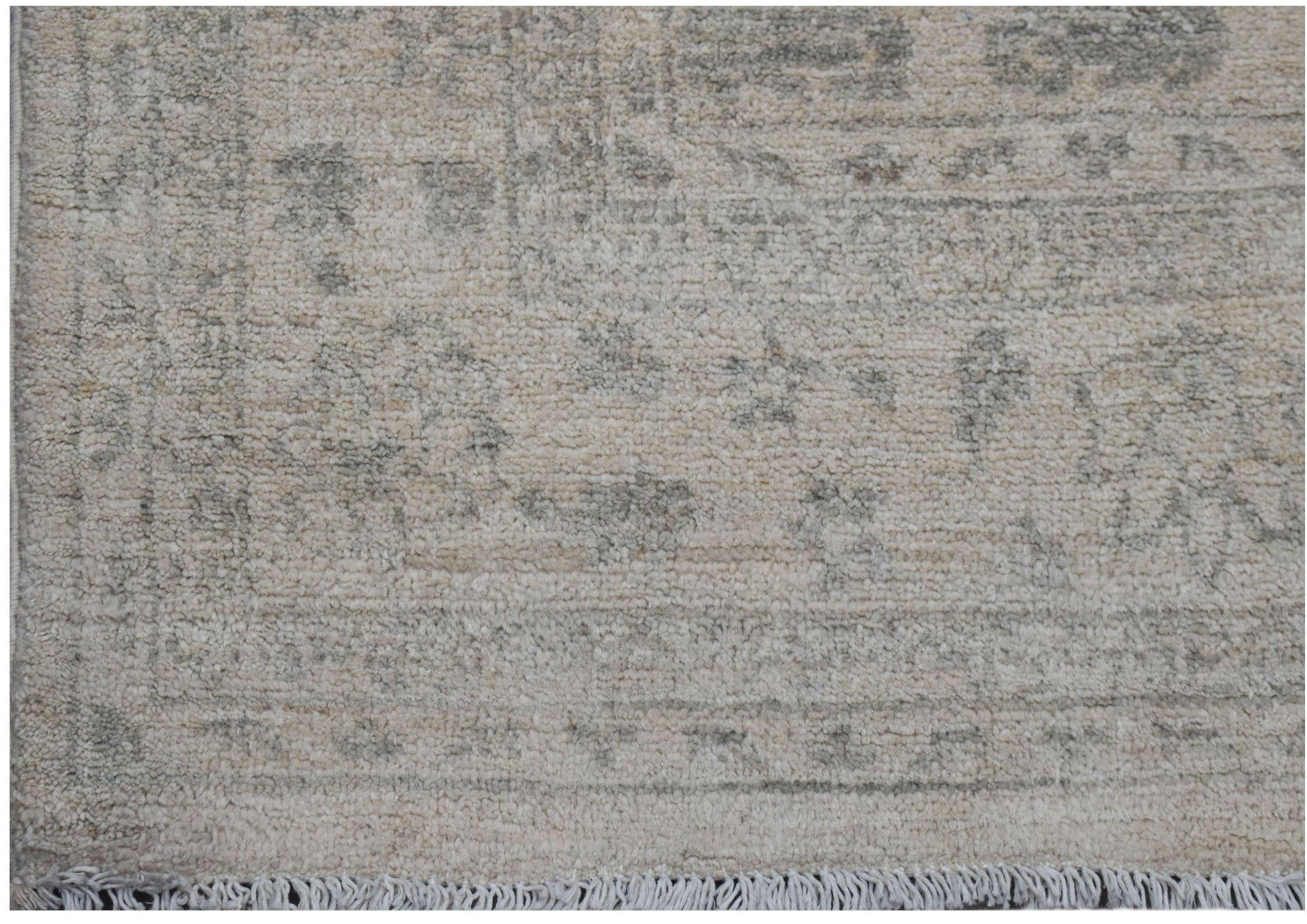 A handwoven Afghan Chobi rug featuring a traditional pattern in soft beige and grey tones.