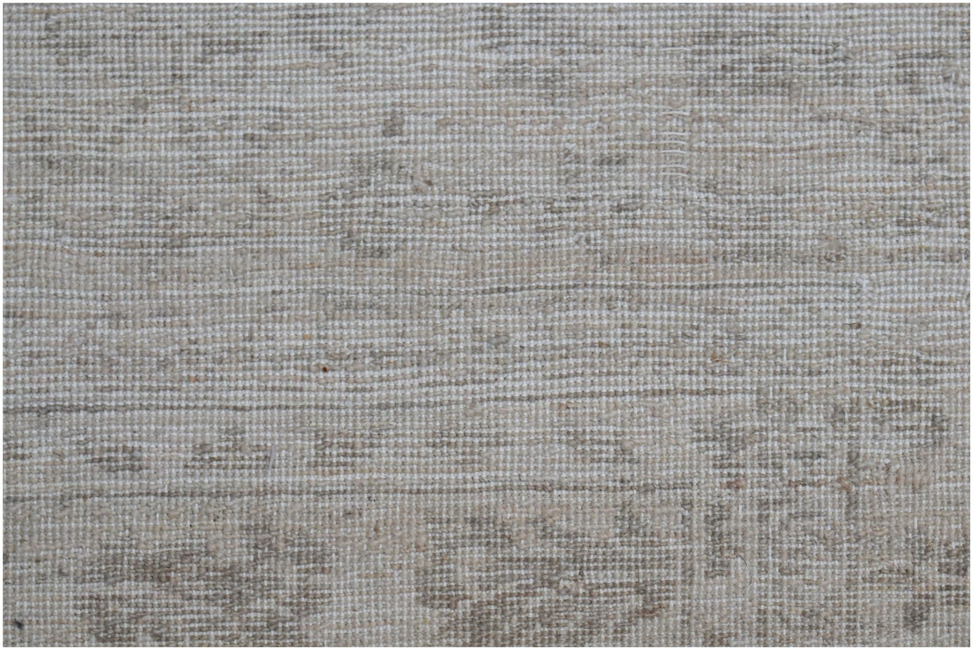 A close-up of a handwoven Afghan Chobi rug featuring a neutral, textured wool pattern.