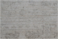 A close-up of a handwoven Afghan Chobi rug featuring a neutral, textured wool pattern.