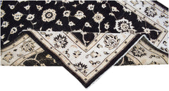 A handwoven Afghan Chobi rug featuring a black field with cream floral patterns and a wide border.