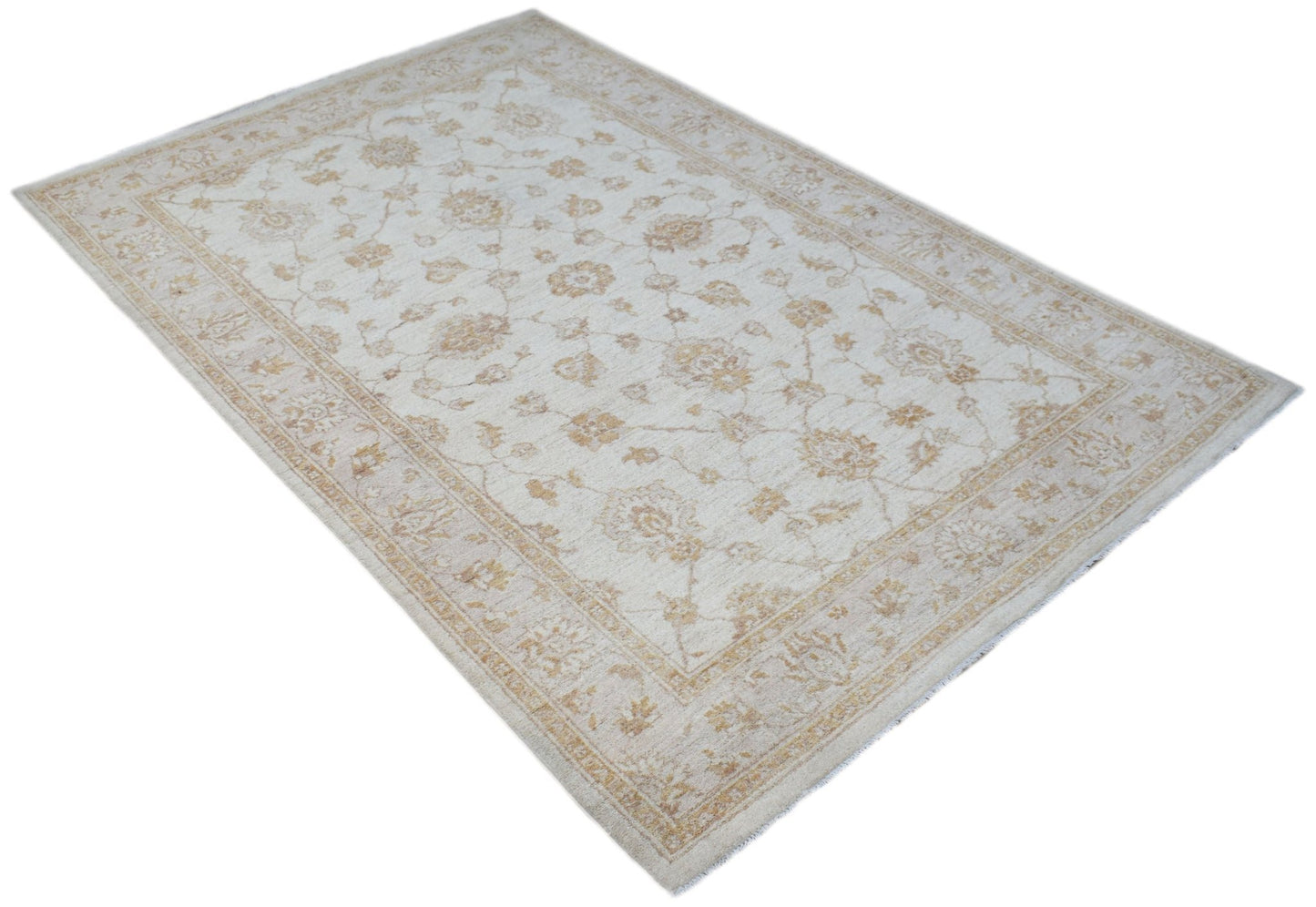 An Afghan Chobi rug featuring a traditional floral pattern in soft beige and tan tones.