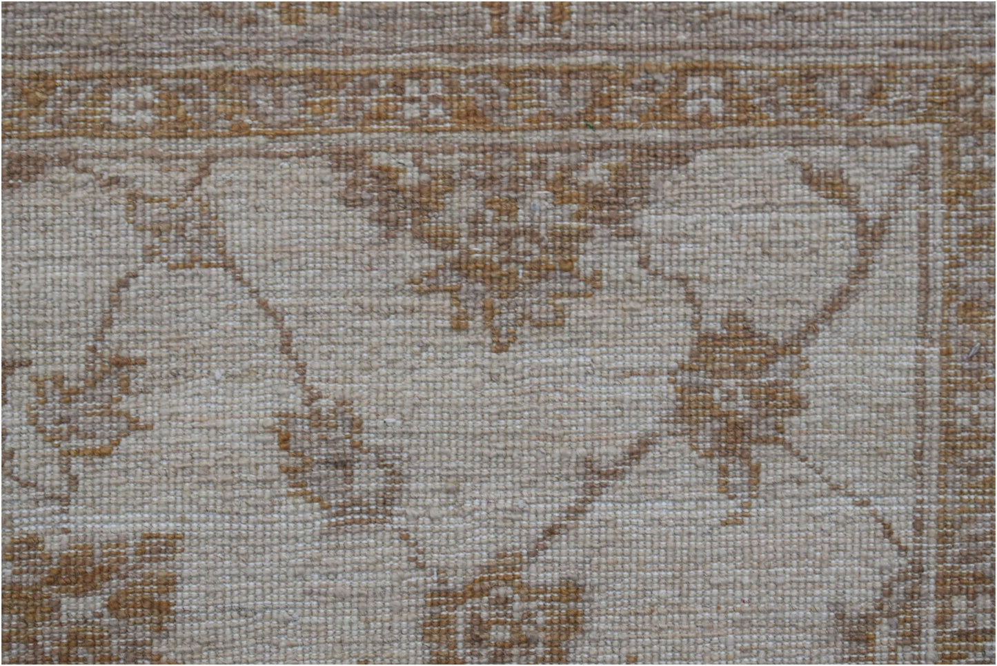 A close-up of a handwoven Afghan Chobi rug featuring traditional floral patterns in earthy tones.