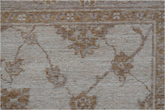 A close-up of a handwoven Afghan Chobi rug featuring traditional floral patterns in earthy tones.