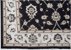 A handmade Afghan Chobi rug featuring a dark field with intricate floral patterns and a light border.