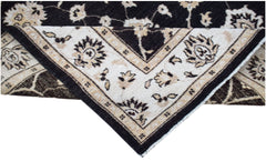A handwoven Afghan Chobi rug featuring a traditional floral pattern in black and cream tones.