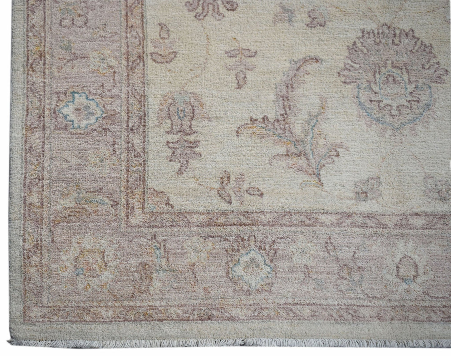 A handmade Afghan Chobi rug featuring a traditional floral pattern in soft, earthy tones.