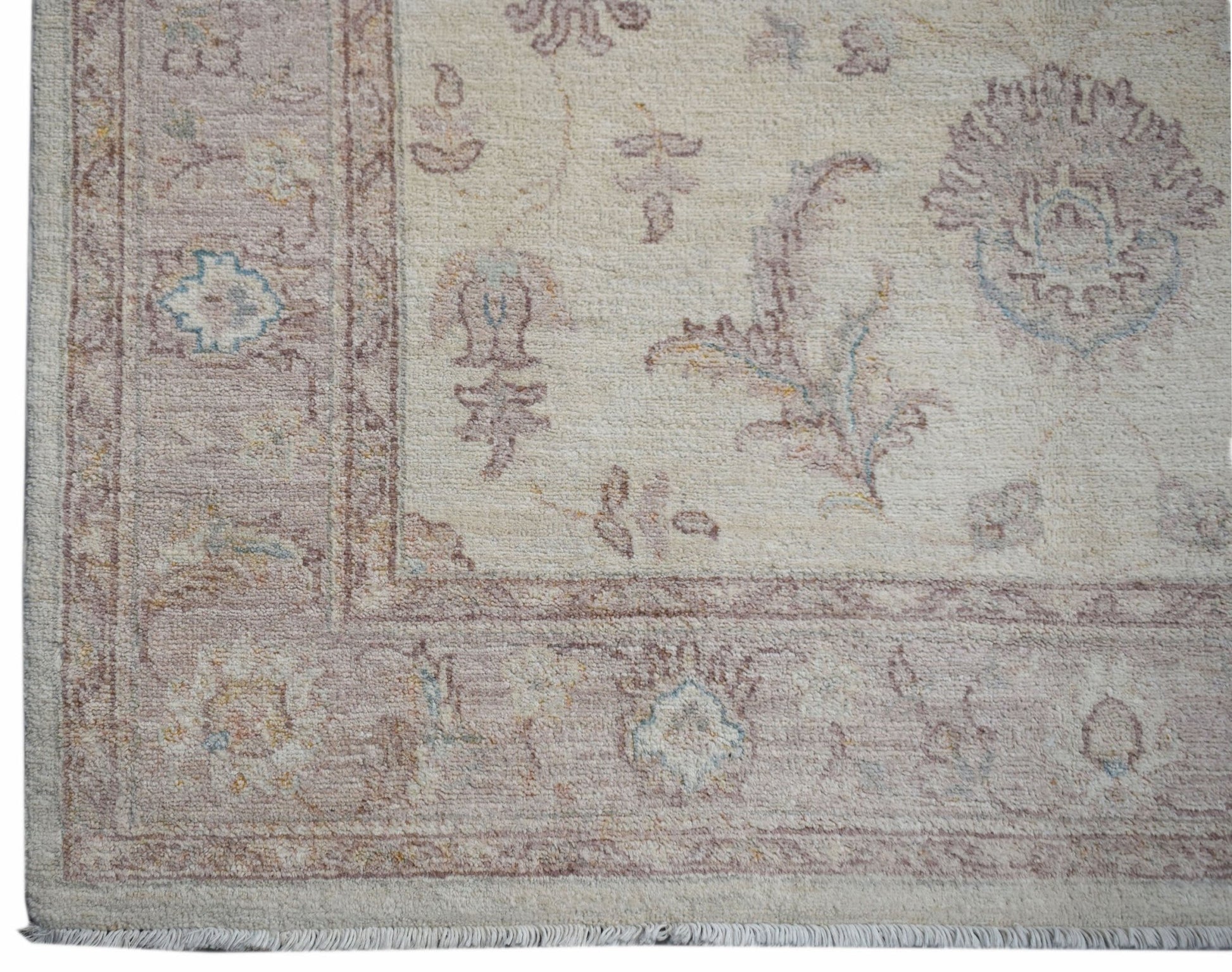 A handmade Afghan Chobi rug featuring a traditional floral pattern in soft, earthy tones.