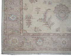 A handmade Afghan Chobi rug featuring a traditional floral pattern in soft, earthy tones.