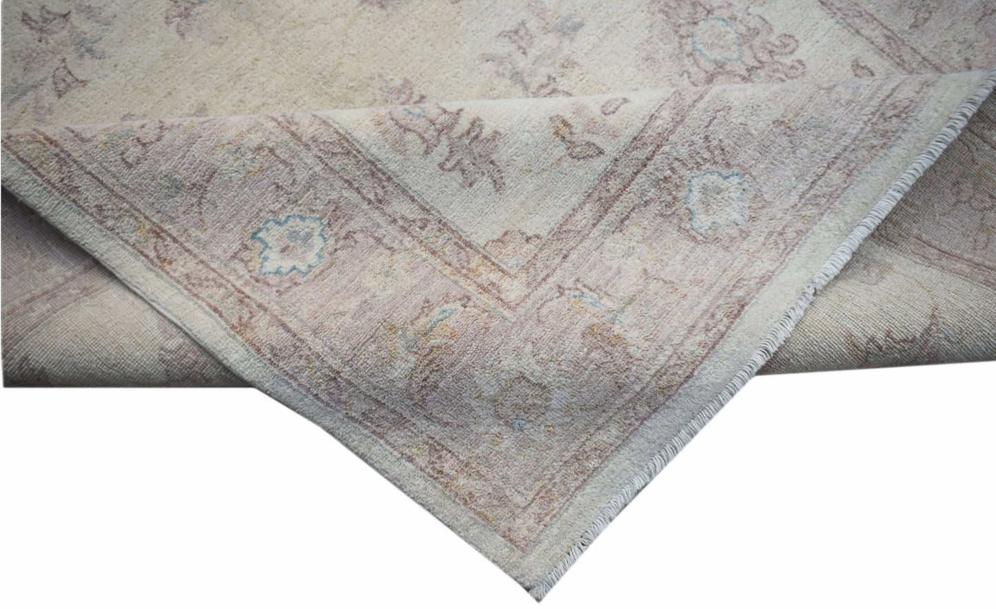 A handmade Afghan Chobi rug featuring a traditional floral pattern in soft, muted earth tones.