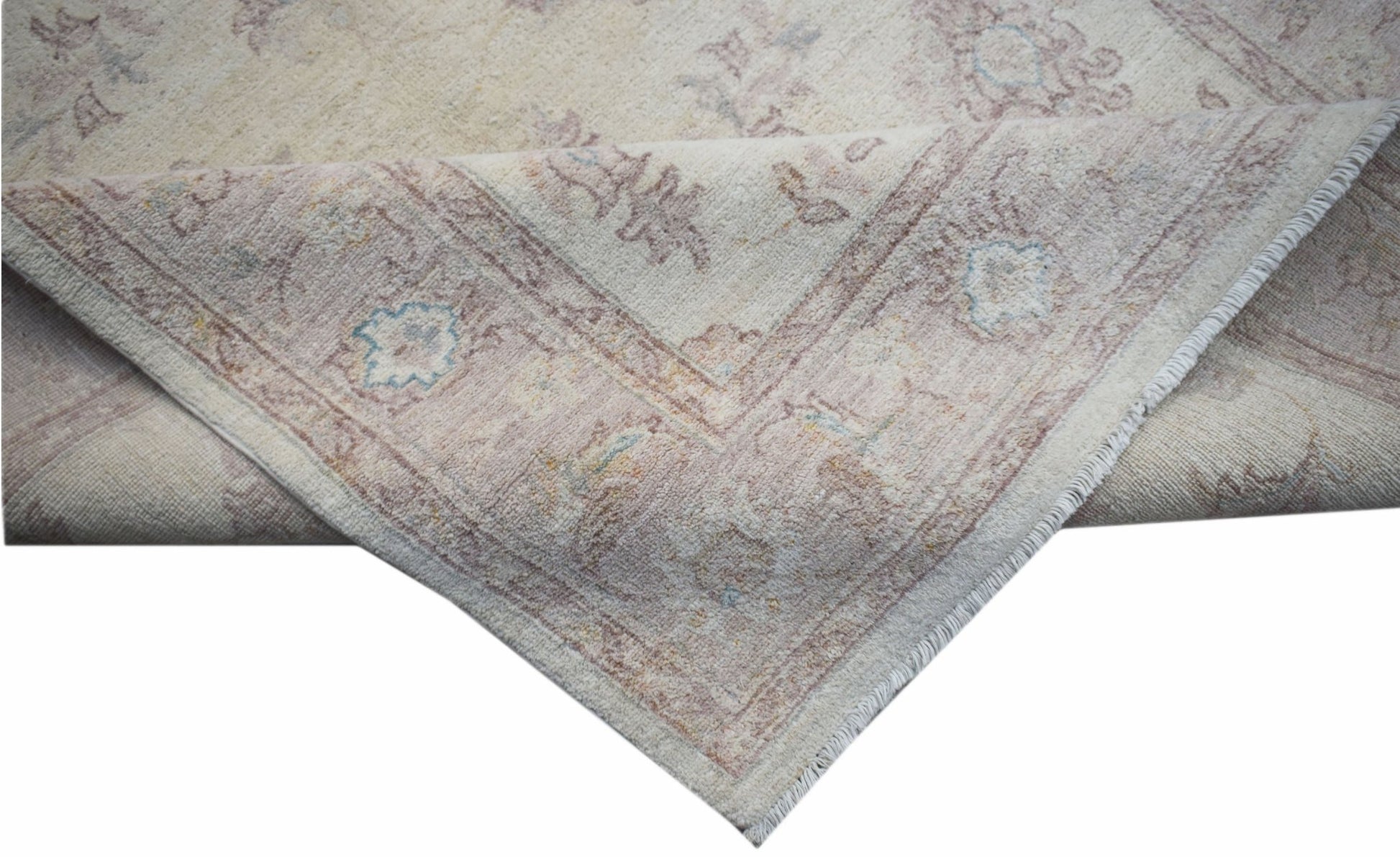 A handmade Afghan Chobi rug featuring a traditional floral pattern in soft, muted earth tones.