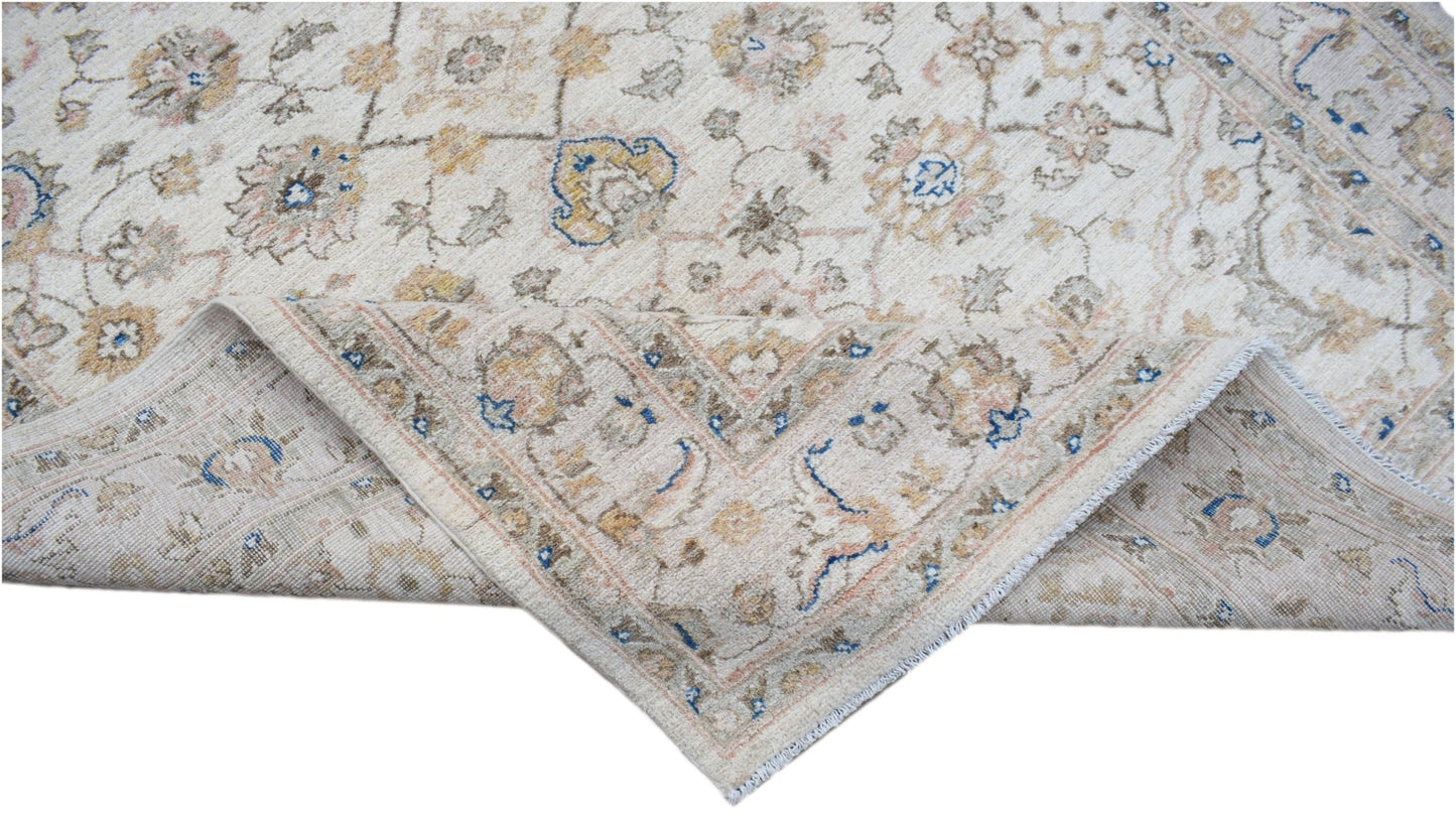 A handmade Afghan Chobi rug featuring a traditional floral pattern in soft beige and blue tones.