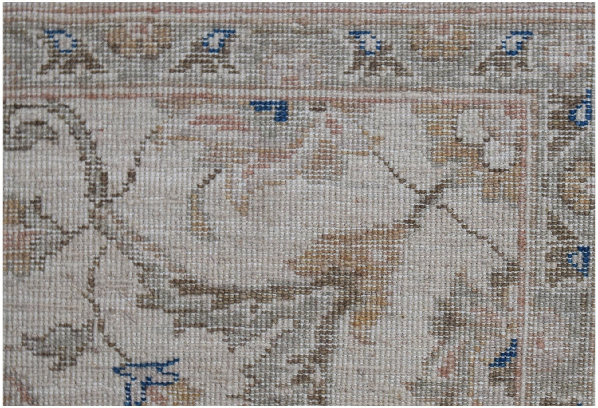 A close-up of a handwoven Afghan Chobi rug featuring traditional floral patterns in earthy tones.
