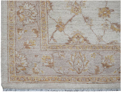 A handwoven Afghan Chobi rug featuring a traditional floral pattern in soft beige and wood tones.