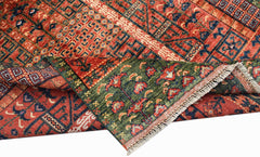 A handwoven Afghan Chobi rug featuring a geometric pattern in red, blue, and green wool.