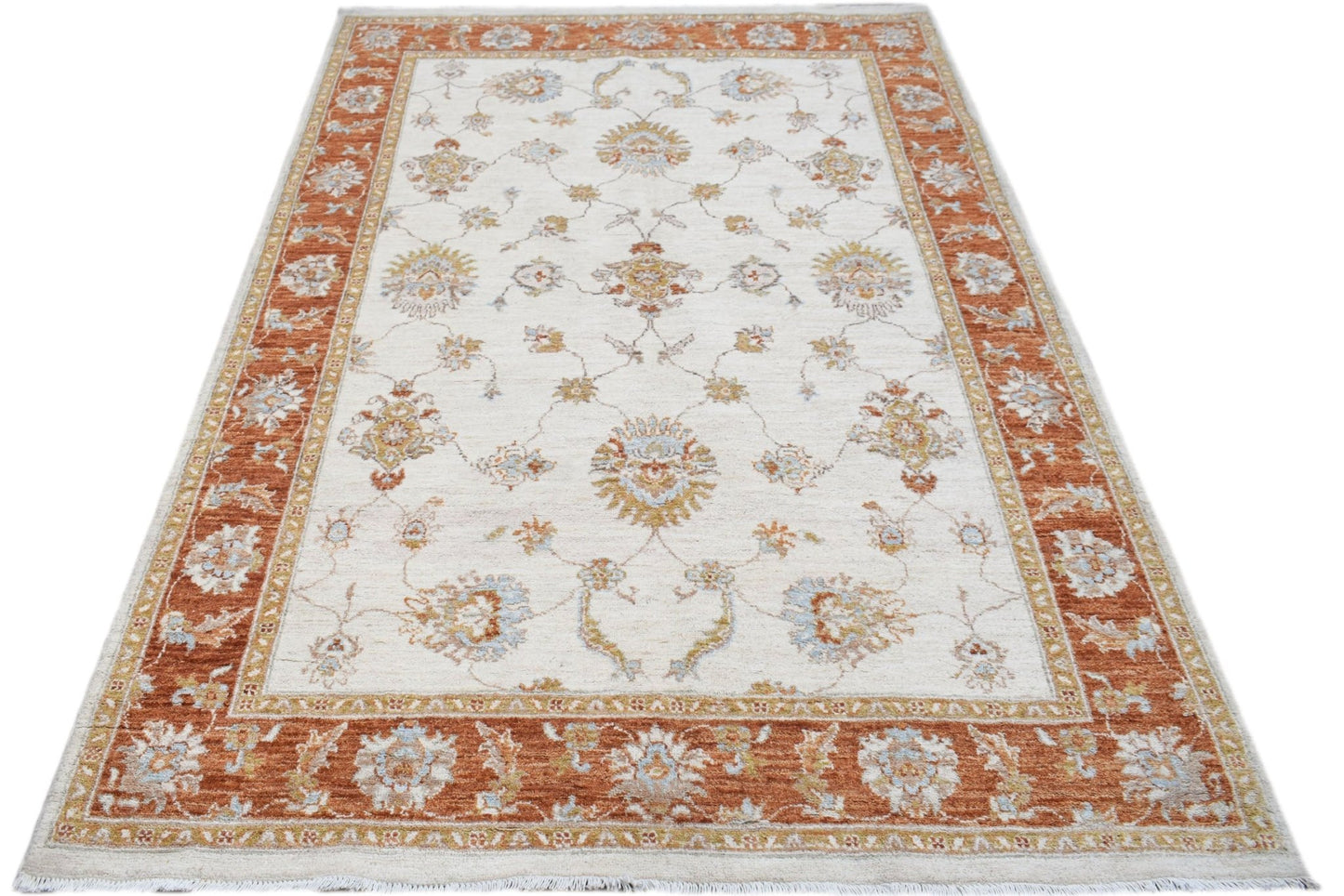 An Afghan Chobi rug featuring a traditional floral pattern in rust and cream tones.