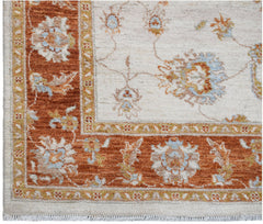 An Afghan Chobi rug featuring a rust-colored floral border on a cream background.