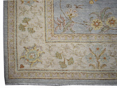A handwoven Afghan Chobi rug featuring a floral pattern in soft blue and cream tones.